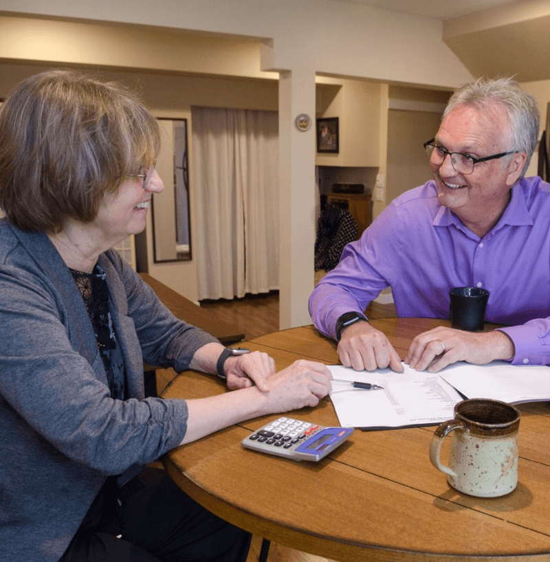 Linda, the owner of Liquidity Bookkeeping, showing a financial document to a client, representing personalized and expert bookkeeping services.